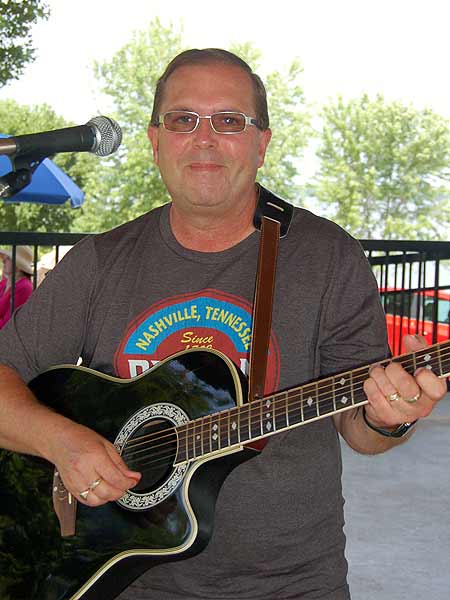 Eldon Ostrom, volunteer musician playing a guitar